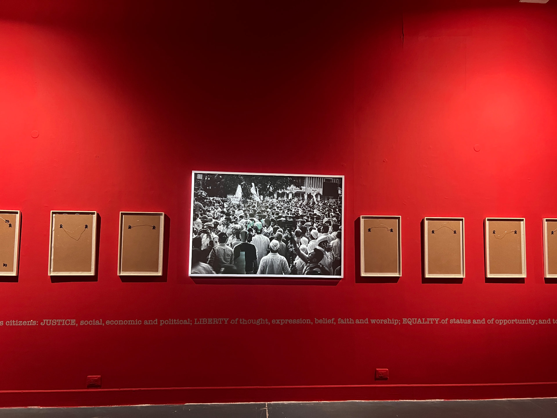 Crowd photograph among empty reversed frames