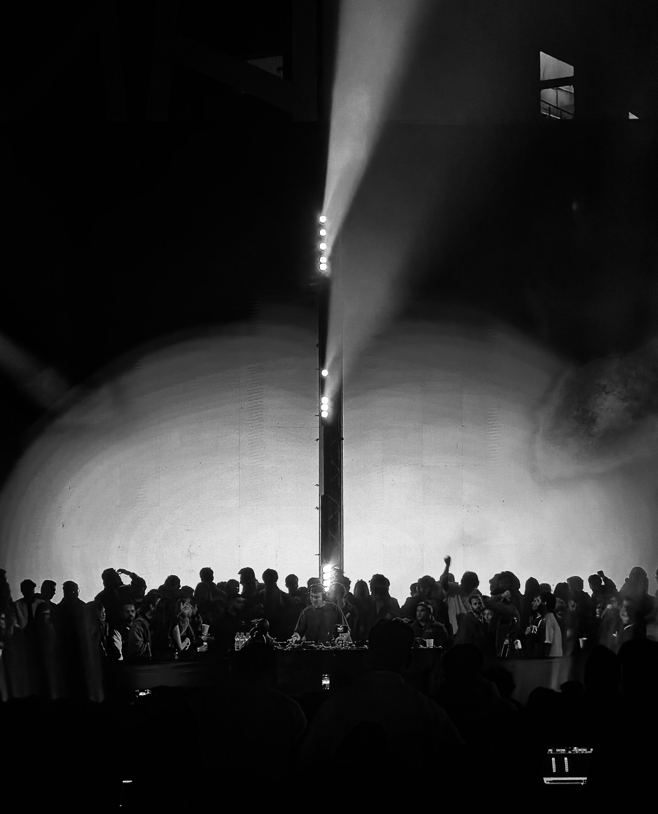 Crowd silhouetted under stage lights